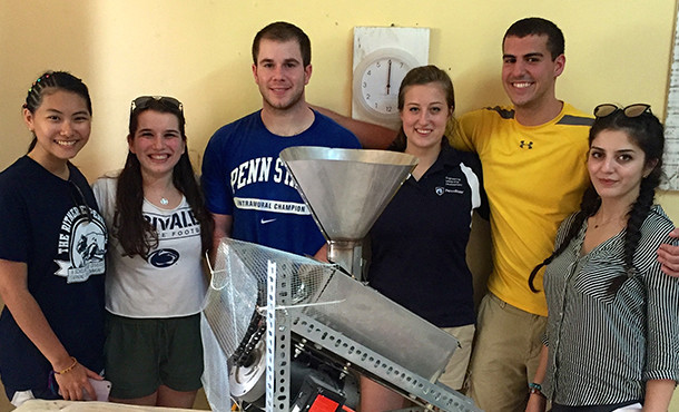 Students standing with baobab processing machine