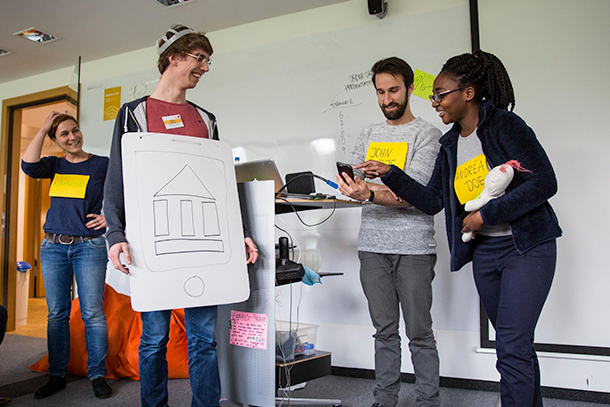 Andrea Sinkpon and team 5 presenting their banking service "Family Planning 2.0" to Design Thinking Week participants