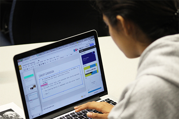 Student working on a PowerPoint slide on concept generation