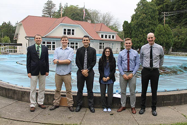 Six people standing in front of Bellefonte's historic Big Spring