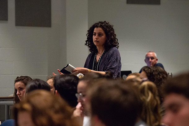 Female student asks a question during a group discussion